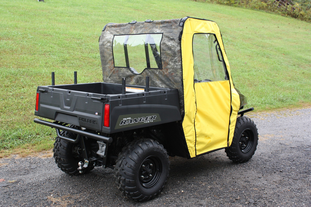 Greene Mountain camo soft doors with clear windows on a yellow mid-size Polaris Ranger, rear 3/4 view on gravel