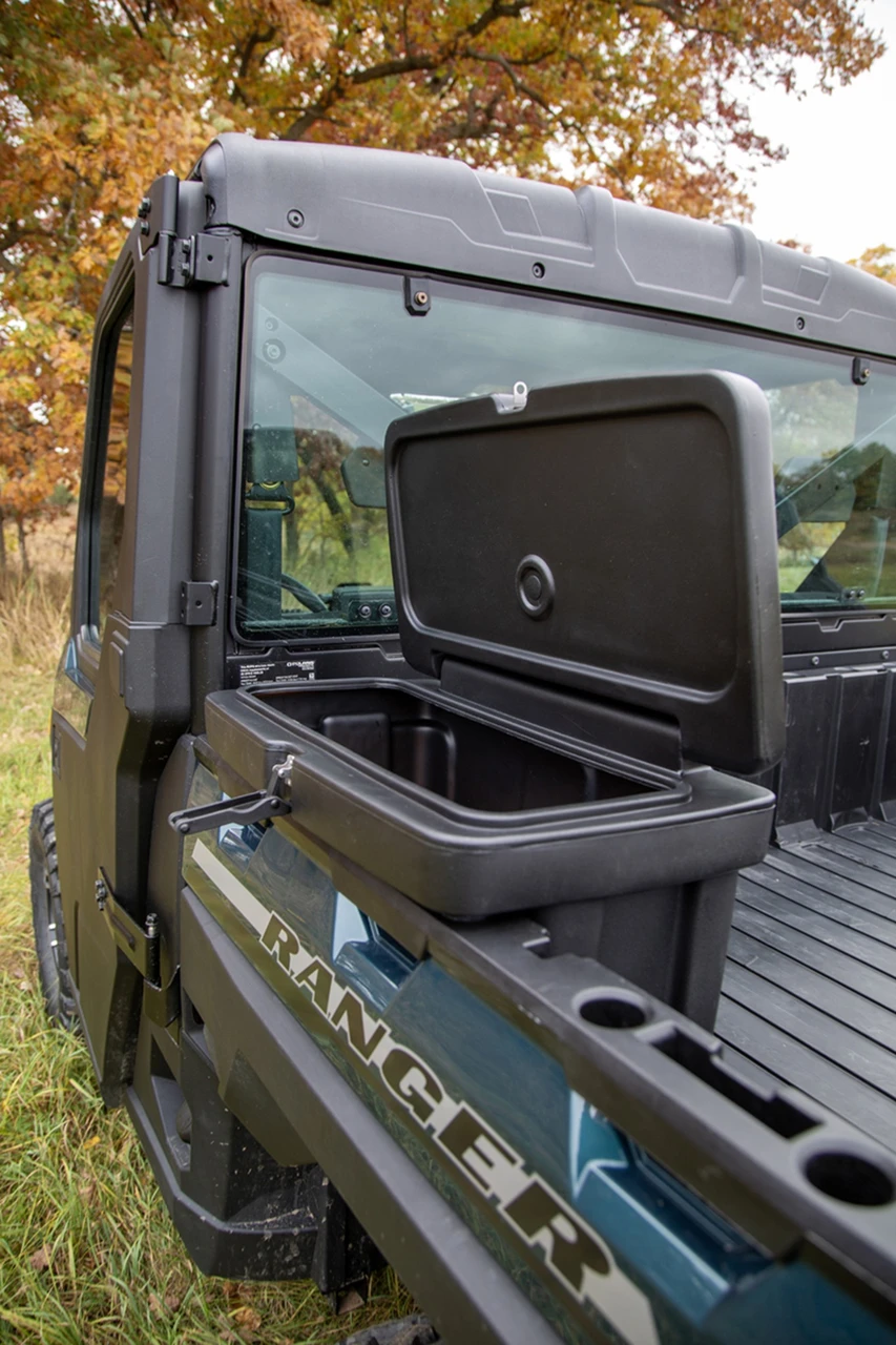 Kolpin saddle storage box with the lid open, mounted behind the cab on a Polaris side-by-side