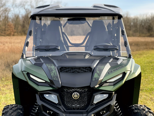 Front view of a green Yamaha RMAX with the Spike Powersports full windshield showing two adjustable vents