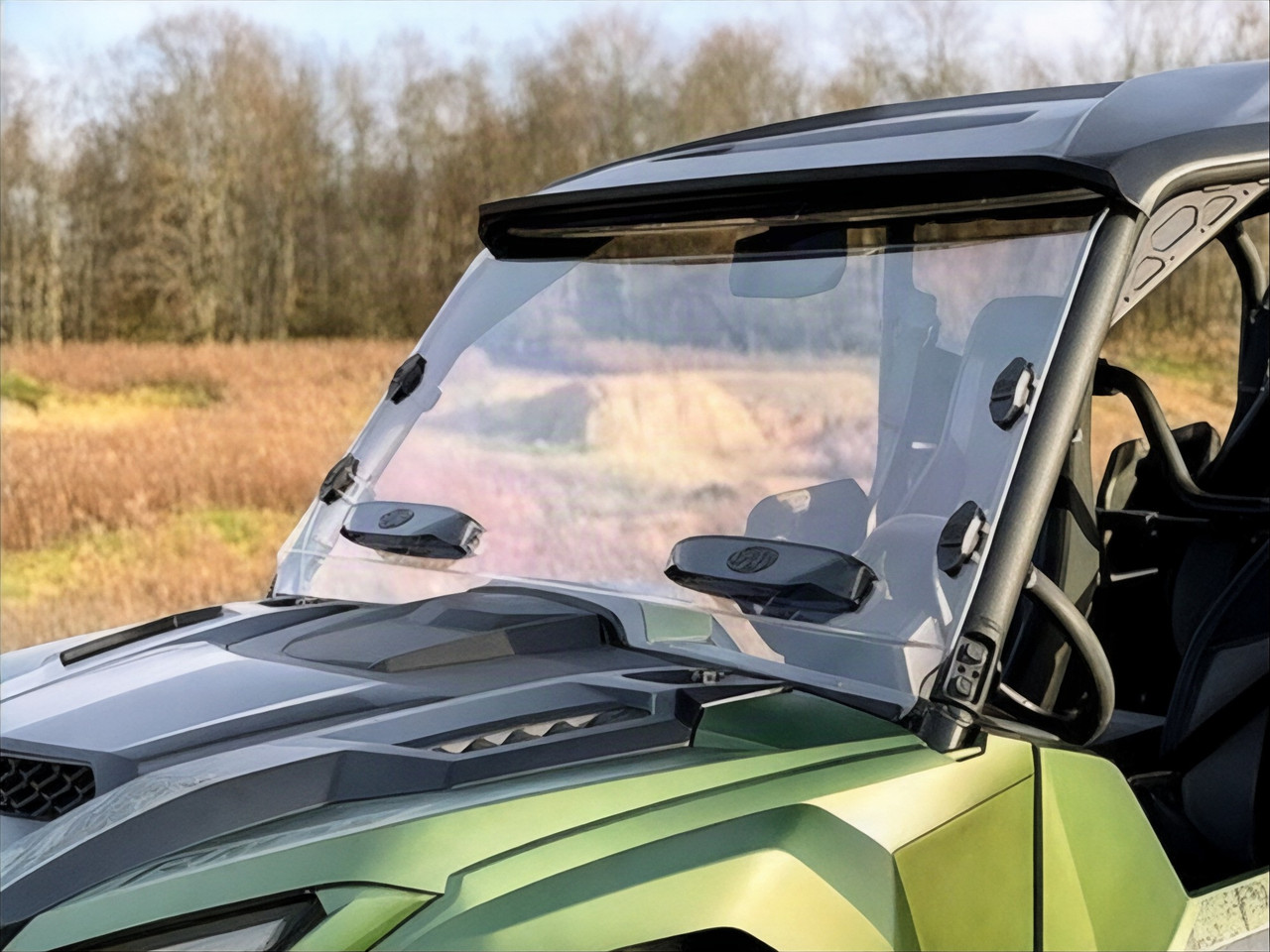 Spike hard-coated full windshield with two vent latches installed on a green Yamaha Wolverine RMAX, front three-quarter