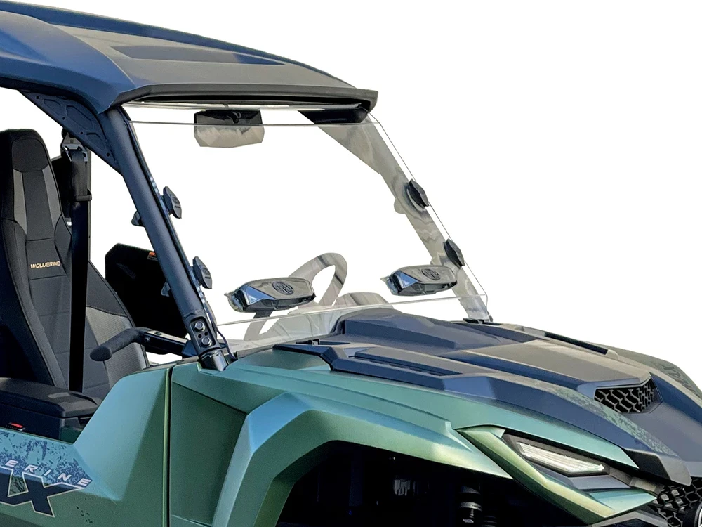 Spike windshield for Yamaha Wolverine RMAX: vented windshield on a green UTV, front corner close-up