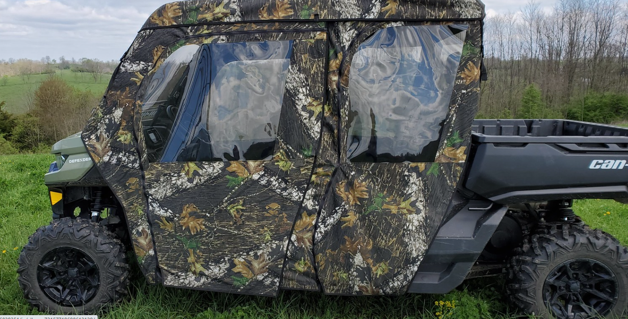 Camo 3 Star soft cab enclosure with doors installed on a green Can-Am Defender Max, side view on grass