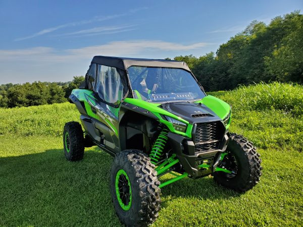 3 Star full cab enclosure installed on a green Kawasaki KRX with a hard windshield, front three-quarter view