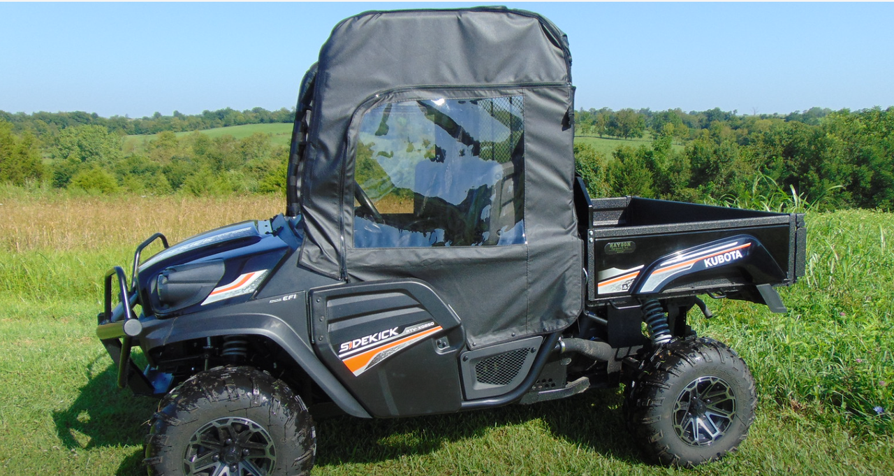 Side view of the 3 Star soft doors with clear windows on a dark blue Kubota RTV XG850 in a field