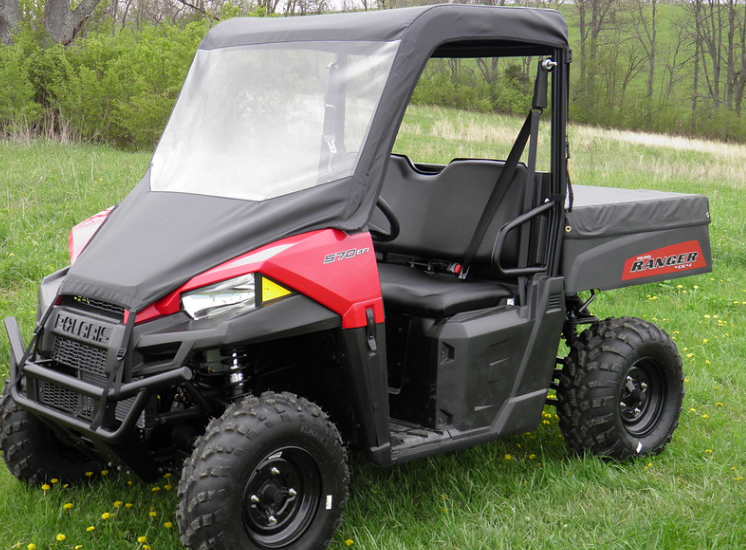 Front three-quarter view of a red Polaris Ranger 570 midsize with the 3 Star vinyl windshield and top combo