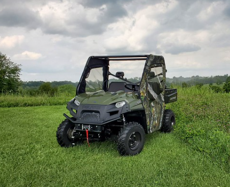 Front three-quarter view of the green Polaris Ranger 570 with the 3 Star camo doors under a cloudy sky