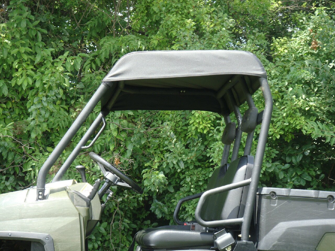 Close-up of the black 3 Star soft top stretched over the cage of a Polaris Ranger 570-3, side view
