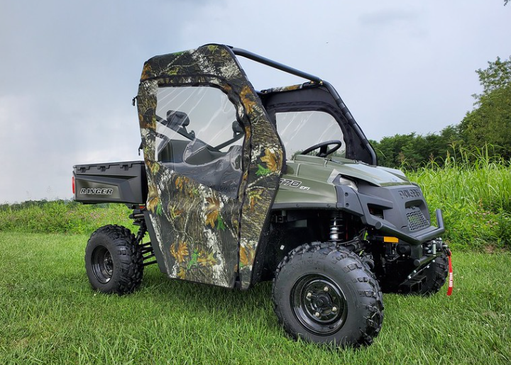 3 Star camo soft doors installed on a green Polaris Ranger 570-3, passenger side view in a grassy field