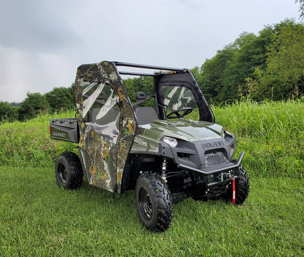 Front three-quarter view of a green Polaris Ranger 570-3 with 3 Star camo soft doors, driver side in a field