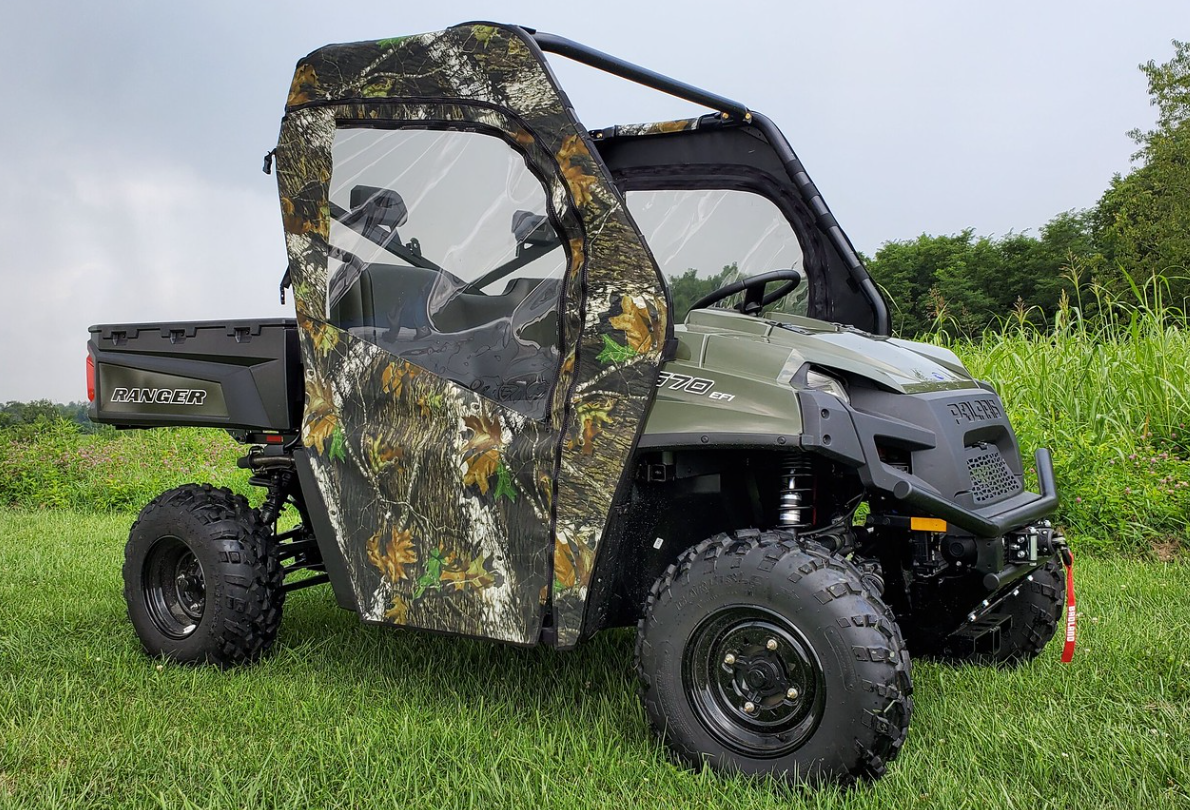 Passenger side front three-quarter view of a green Polaris Ranger 570-3 with 3 Star camo soft doors zipped closed