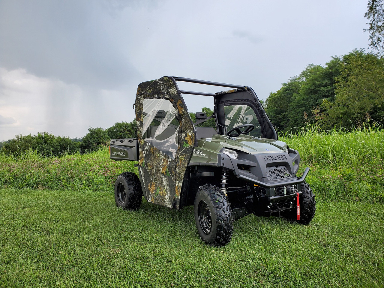 3 Star camo soft doors on an olive Polaris Ranger 570-3, front 3/4 view in a field