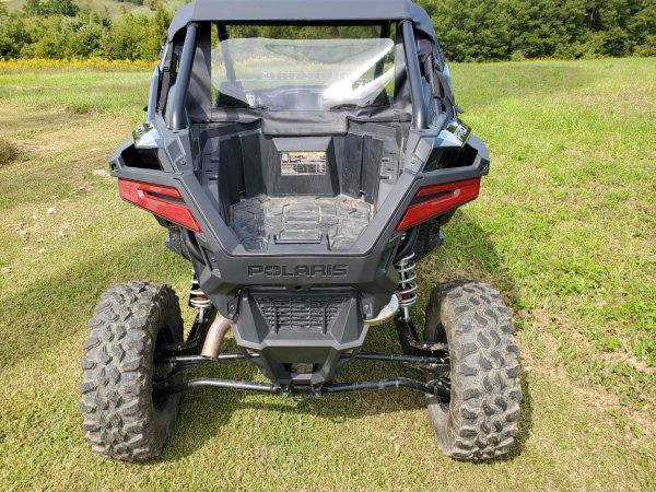 Rear view of a black Polaris RZR Pro XP with the 3 Star soft back panel and clear window behind the seats