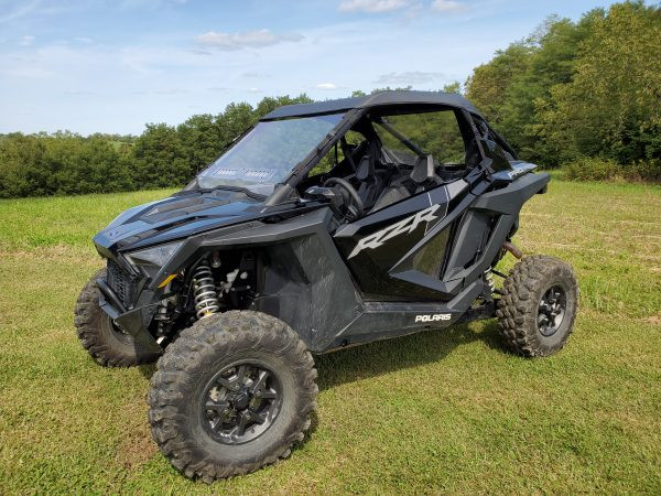 3 Star one-piece windshield on a black Polaris RZR Pro XP, front three-quarter view in a field