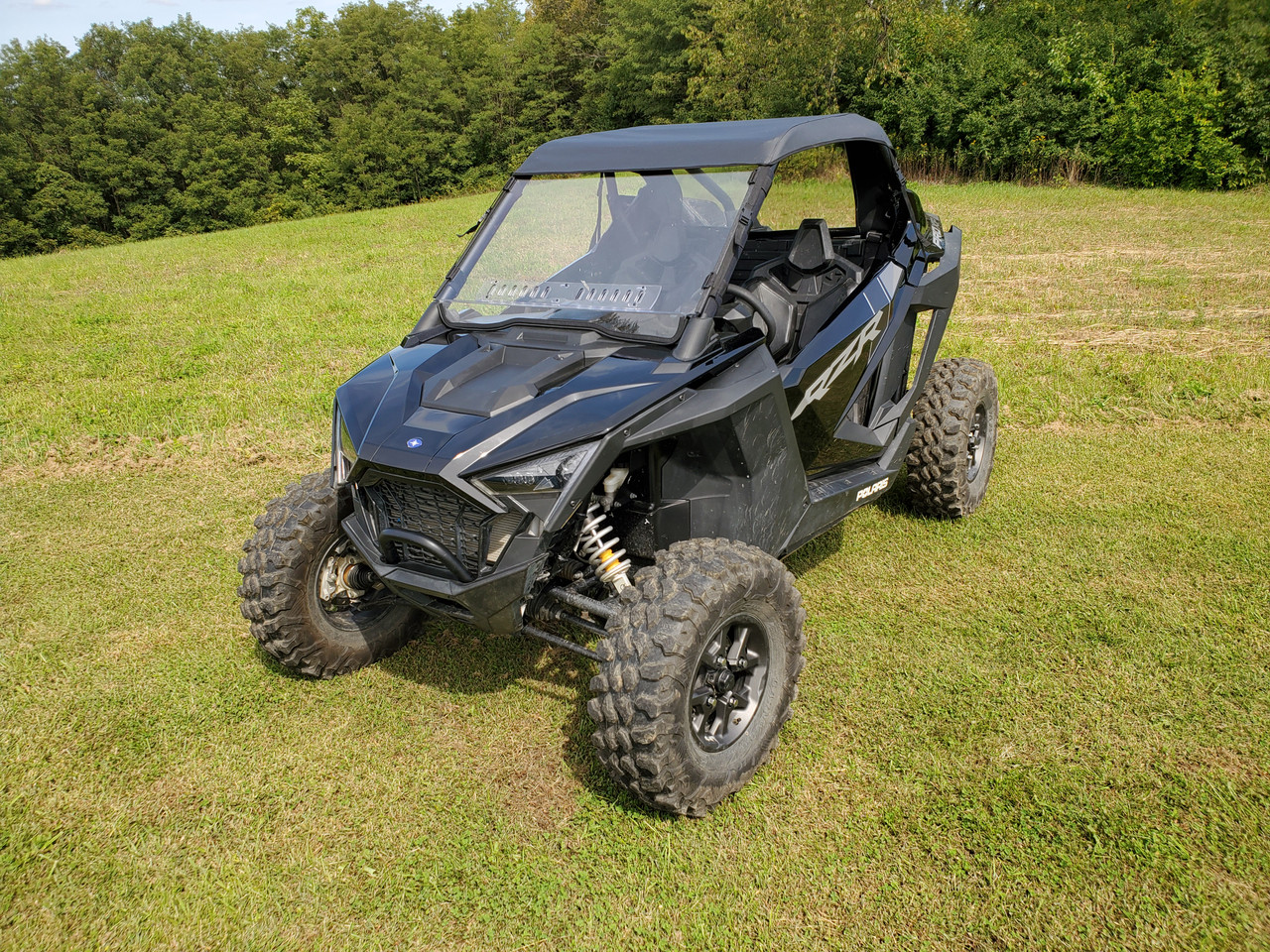 Passenger side front three-quarter view of a Polaris RZR Pro XP with the 3 Star one-piece windshield