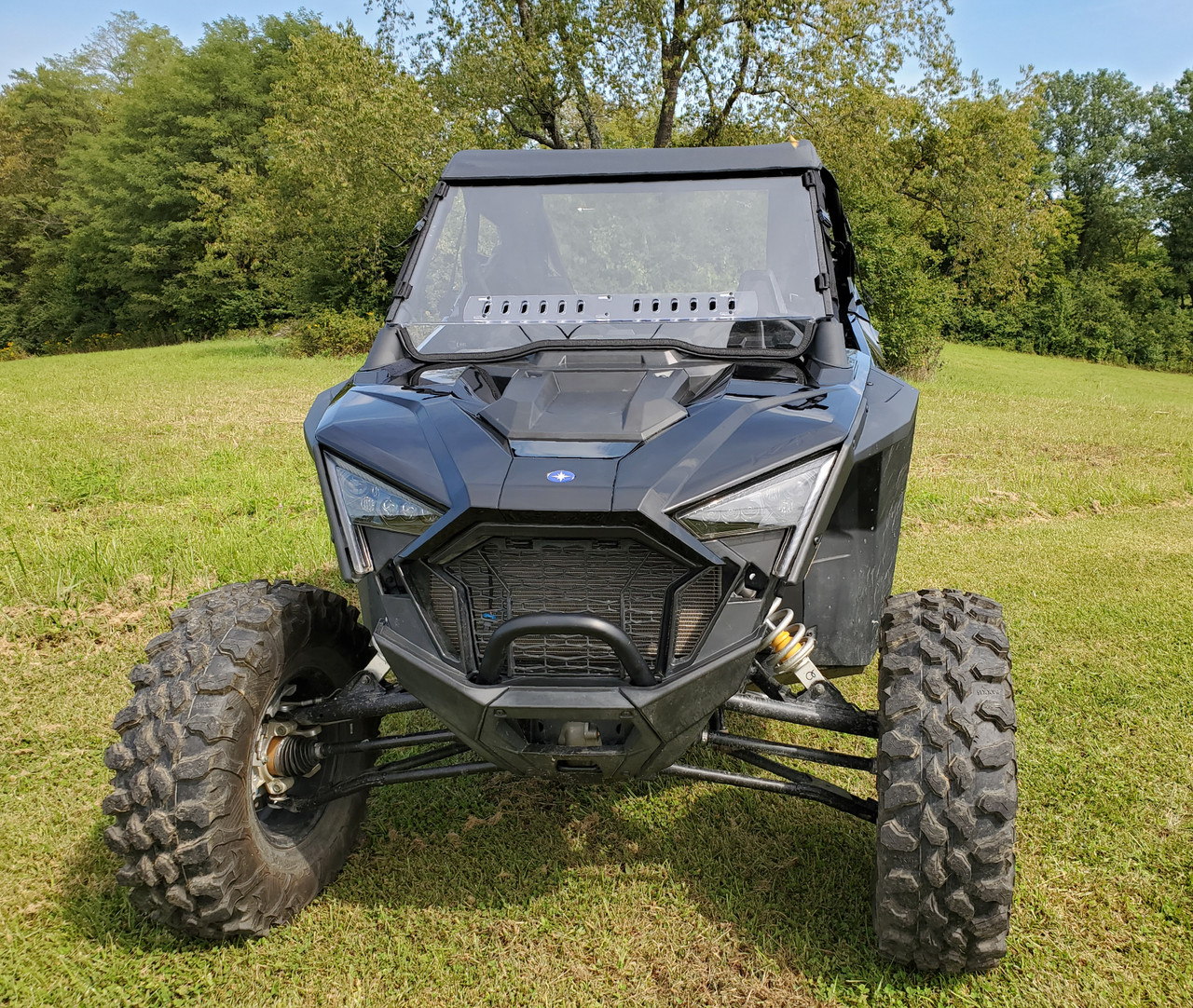 Front view of a black Polaris RZR Pro XP with the 3 Star one-piece windshield and vent slots