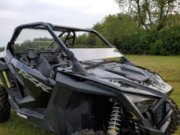 3 Star half windshield on a black Polaris RZR Pro XP, driver side front three-quarter view in a field