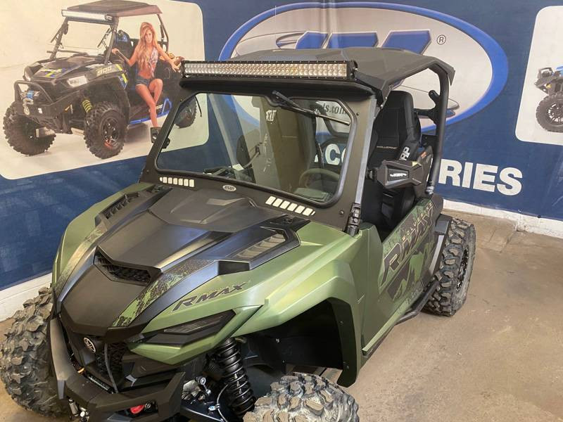 Front three-quarter view of the green Yamaha Wolverine RMAX 1000 with the Extreme Metal Products windshield and light bar
