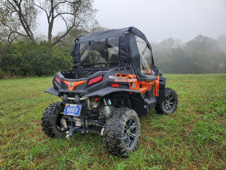 Rear view of an orange CF Moto ZForce with the 3 Star upper doors and rear window installed