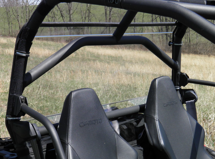 Front-facing view of the 3 Star Lexan rear window clamped to the cage behind the CFMoto ZForce seat headrests