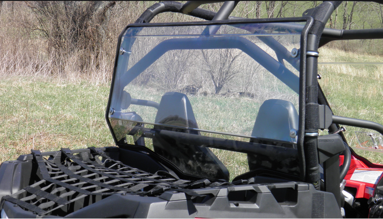 Wide rear angled view of the 3 Star Lexan rear window on the red CFMoto ZForce with the cargo net below