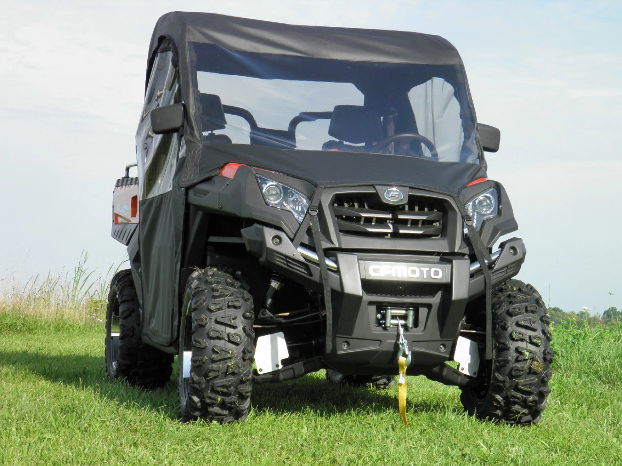 3 Star full cab with vinyl windshield and upper doors on a black CF Moto UForce 800, front three-quarter view in a field