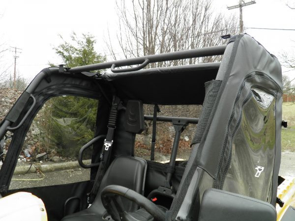 View across the cab of a yellow Cub Cadet Challenger showing the 3 Star soft door with clear window from the inside
