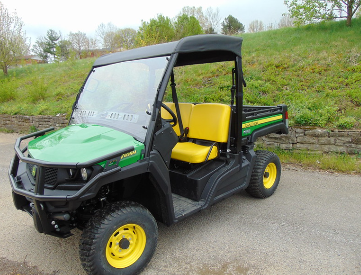 3 Star black soft top installed on a green and yellow John Deere Gator 835 with windshield, front three-quarter view