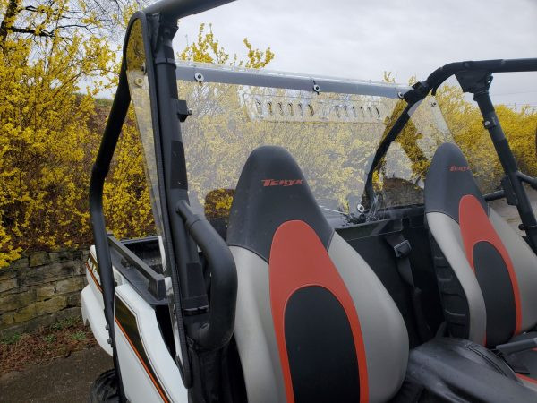 Side view of the 3 Star clear Lexan rear window with vent slots behind the red and gray Kawasaki Teryx 800 seats