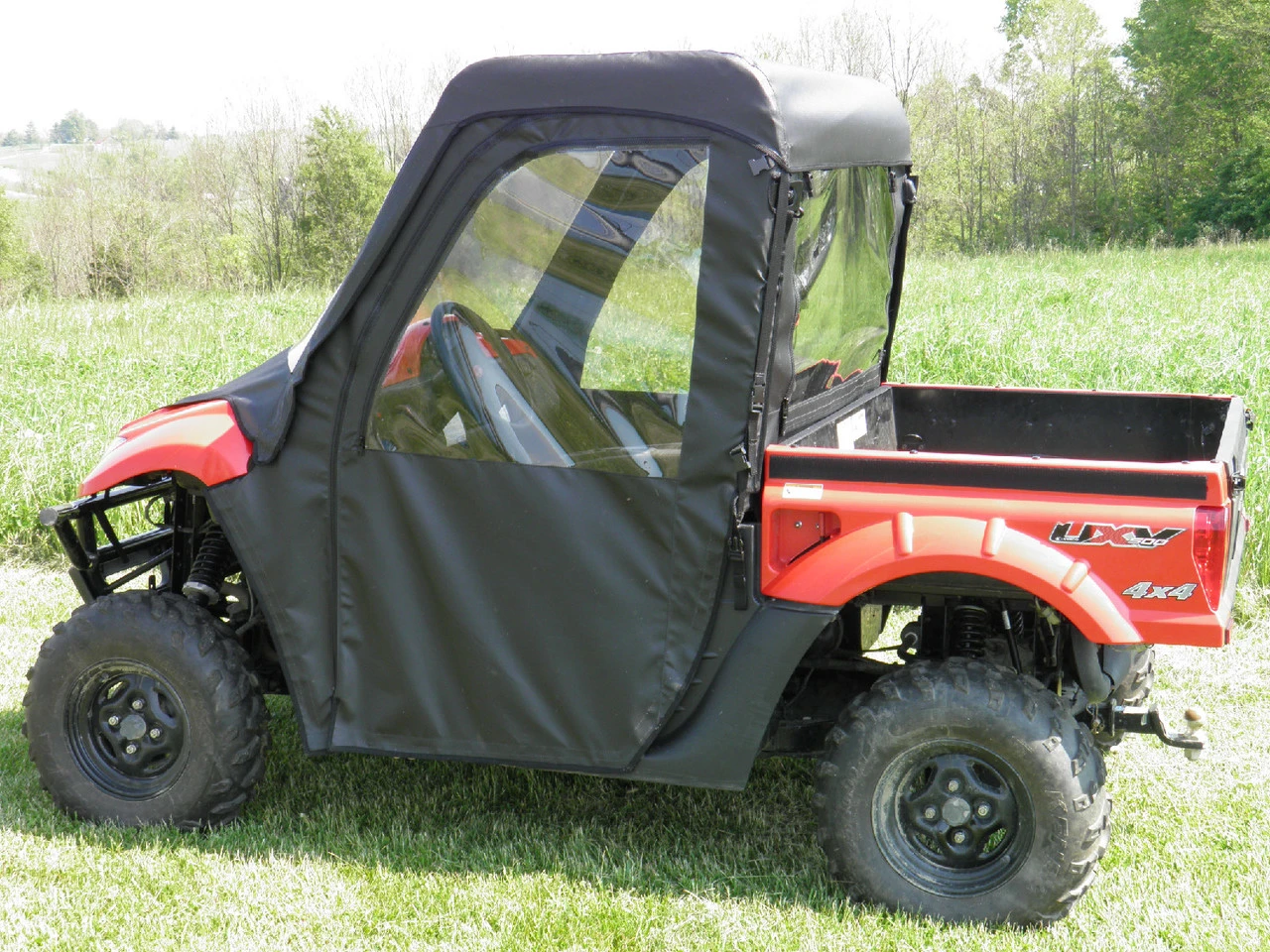 Side view of a red Kymco 700i wearing the 3 Star full cab enclosure with clear door and rear windows