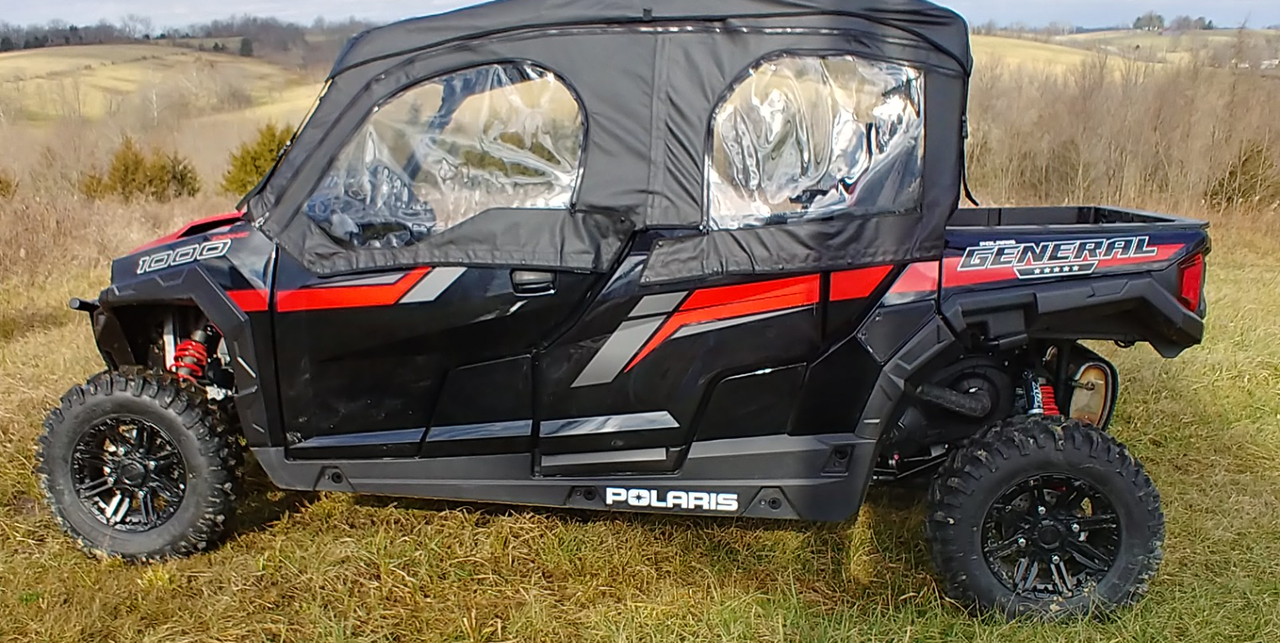 Side view of a black and red Polaris General Crew with the 3 Star full cab enclosure and clear windows