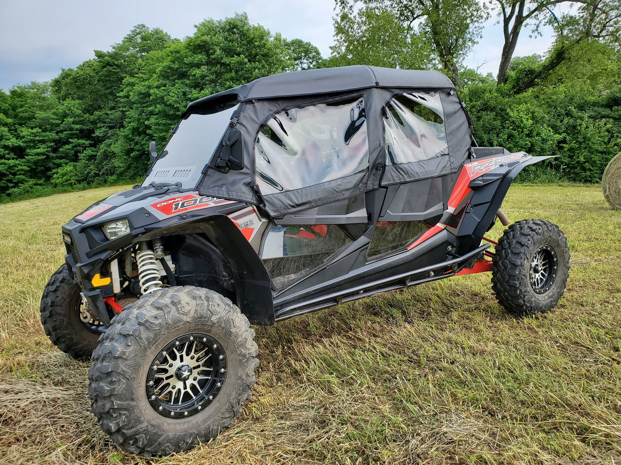 3 Star full cab enclosure on a red and black Polaris RZR XP 4 1000, black cab with clear windows, front 3/4 view
