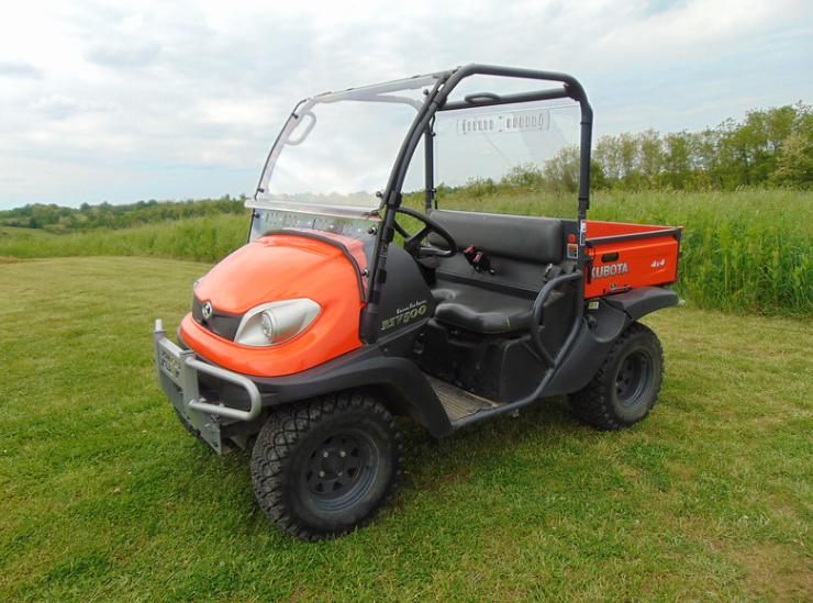 3 Star Lexan rear window installed on an orange Kubota RTV X900/X1120D, front three-quarter view