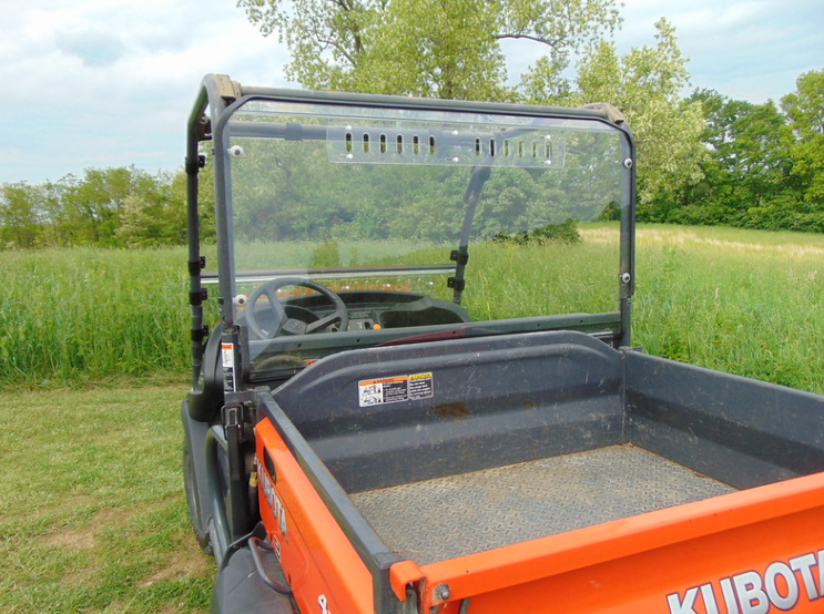 Close-up of the 3 Star Lexan rear window with vent slots on a Kubota RTV X900/X1120D from the bed