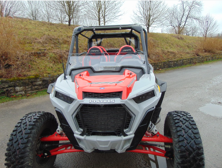 3 Star half windshield on a red and gray Polaris RZR XP 4 Turbo S, straight front view on a paved road