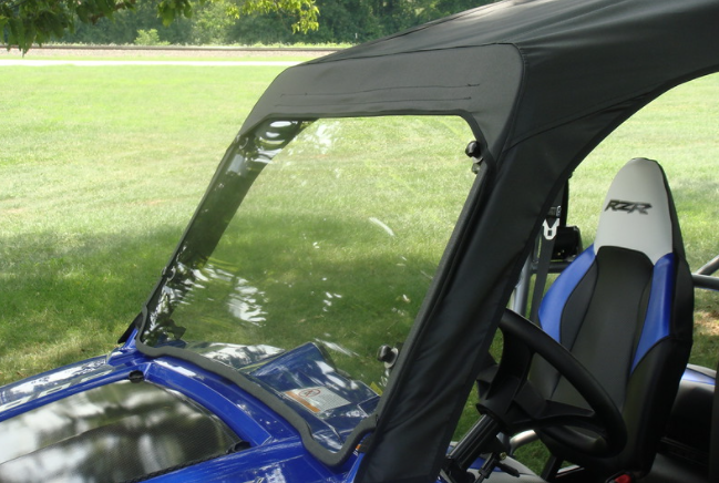 Angled view of the 3 Star one-piece windshield and soft top edge on a blue Polaris RZR XP 900-4