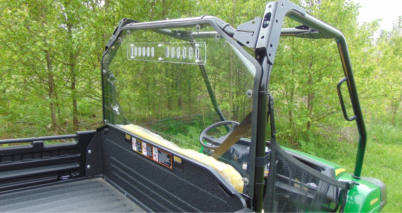 3 Star Lexan back panel installed on a green John Deere Gator XUV, clear panel with vent slots seen from the bed