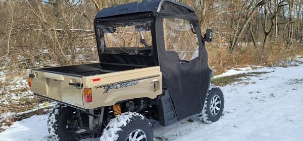 Rear passenger-side view of the Side X Side cab enclosure on the Massimo T-Boss 410 in snow