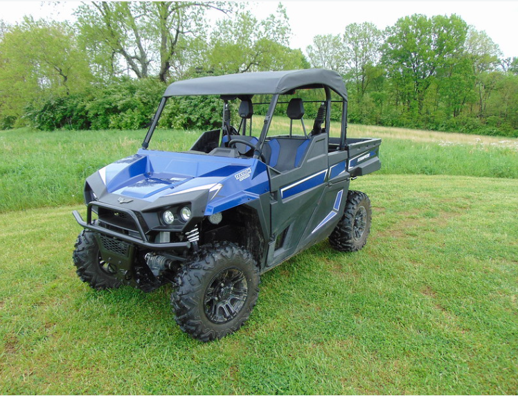 3 Star soft top on a blue Arctic Cat Stampede, front three-quarter view in a grassy field