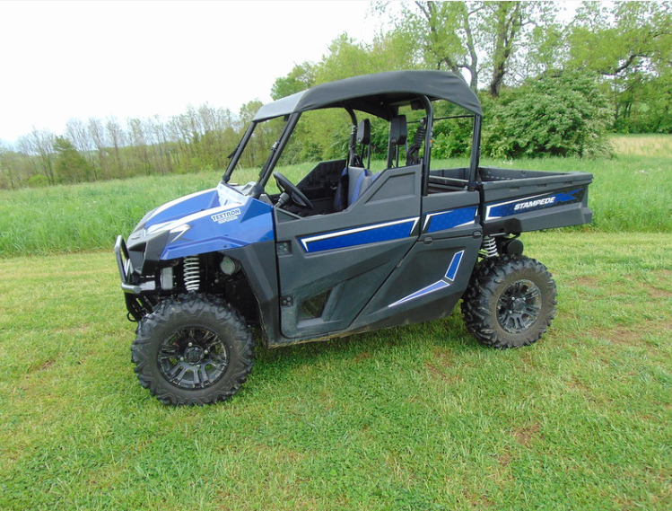 Passenger side front angle of a blue Arctic Cat Stampede wearing the 3 Star black soft top