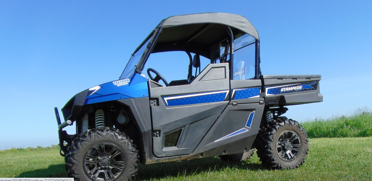 Driver side profile of a blue Arctic Cat Stampede with the 3 Star soft top, cropped wide view