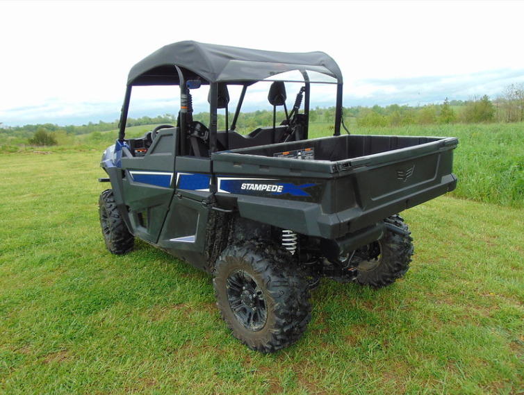 3 Star soft top for hard windshield on a blue Arctic Cat Stampede, rear three-quarter view in a field