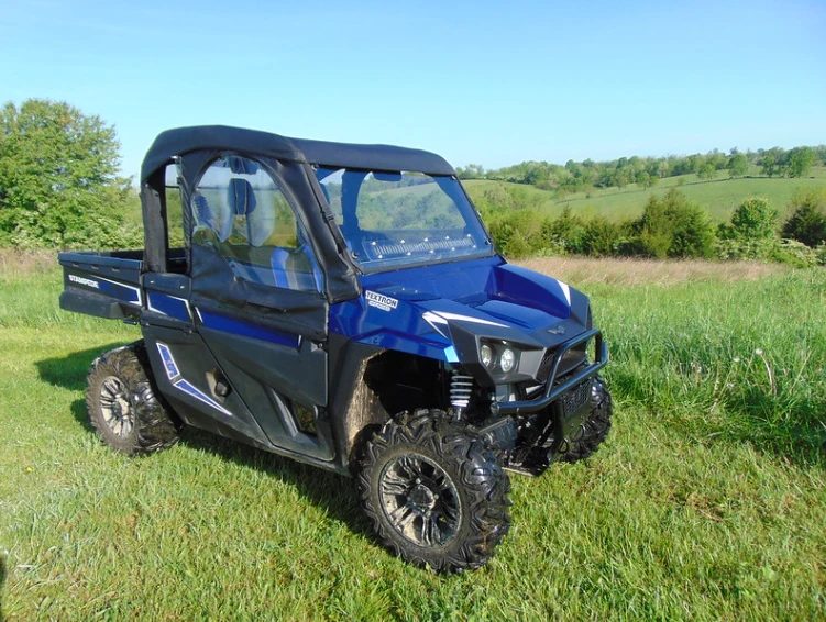 Front three-quarter view of a blue Arctic Cat Stampede with the 3 Star soft doors zipped closed, passenger side