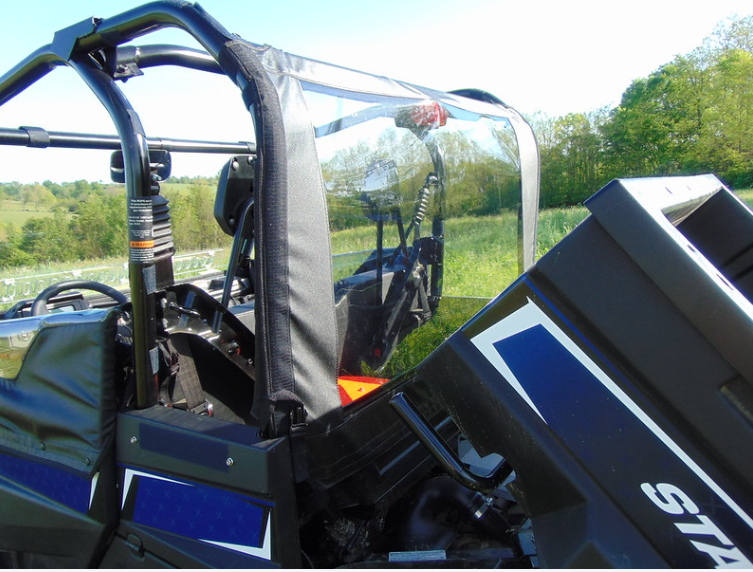 Passenger side view of the 3 Star soft rear window on an Arctic Cat Stampede with the bed tilted up