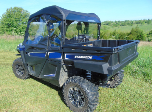 Passenger-side rear three-quarter view of the Arctic Cat Stampede with soft top and the 3 Star Lexan back panel