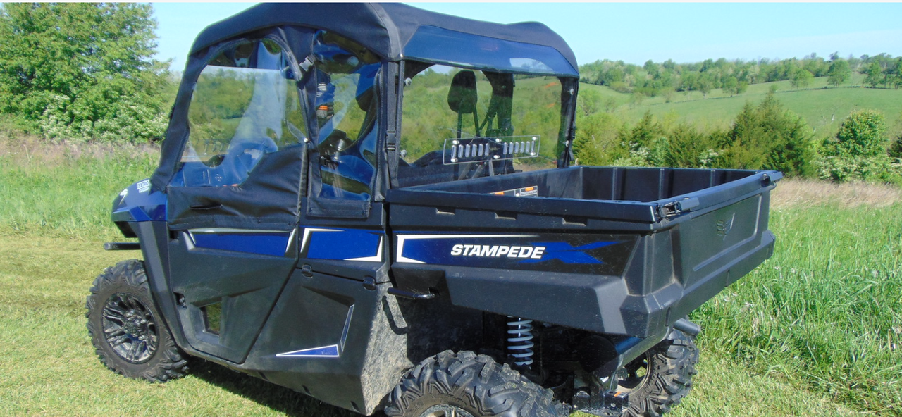 Wide side view of the blue Arctic Cat Stampede with soft top, doors and the 3 Star back panel