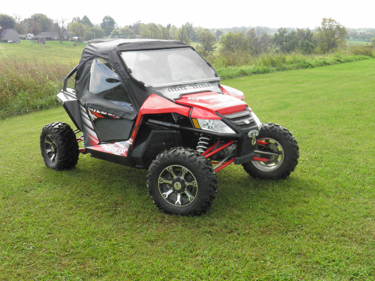Arctic Cat Wildcat with the 3 Star soft top and upper door kit, front view parked in a mowed field