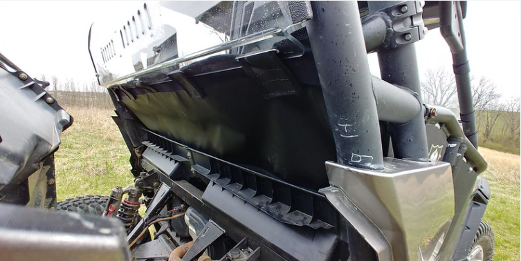 Low angle from beside the rear wheel of the Can-Am Commander showing the 3 Star rear window and lower panel edge