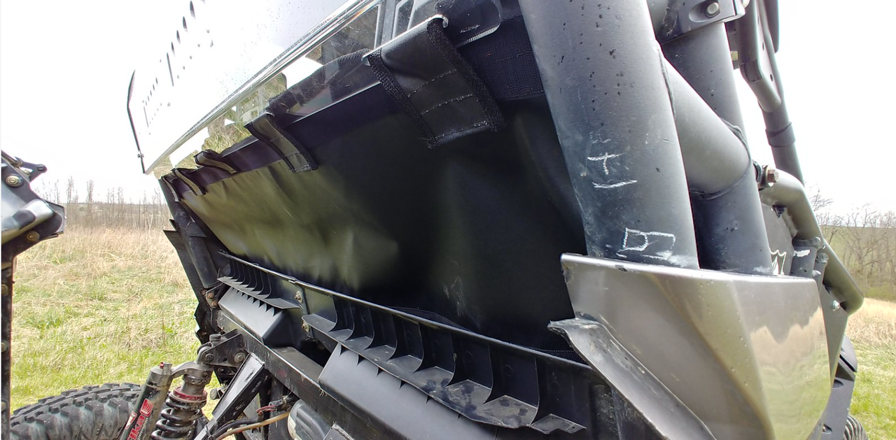 Angled close-up of the 3 Star rear window edge and black lower back panel where it meets the Can-Am Commander cage tube