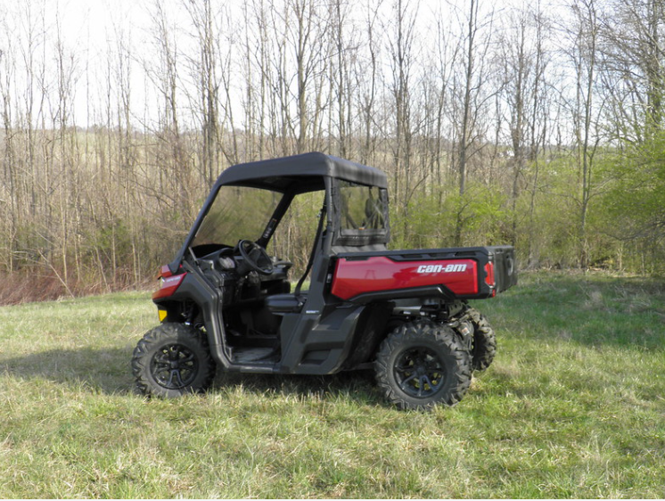 Side view of a red Can-Am Defender fitted with the 3 Star soft top and vinyl rear window
