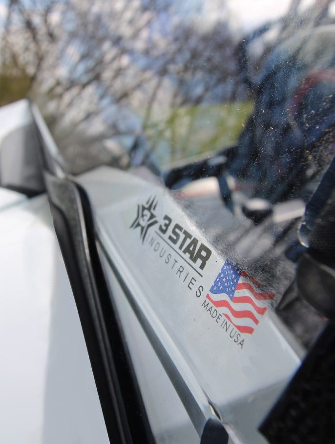 Close-up of the 3 Star logo decal on the edge of the two-piece windshield for the Can-Am Maverick X3